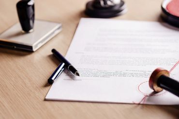 Business contract signing at professional desk